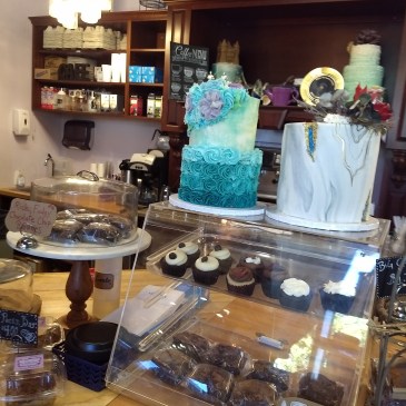 Part of the counter at Sweet T's, with two full-size cakes and a few smaller displays